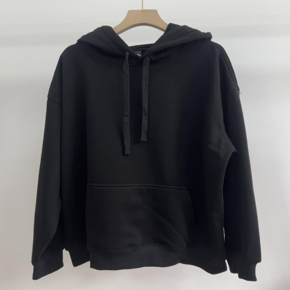 Unisex black hoodie with custom logo print – wholesale promotional apparel for organizations
